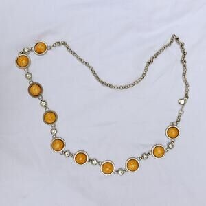 silver and orange waist belt